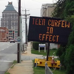 Sign announcing teen curfew in downtown Greensboro